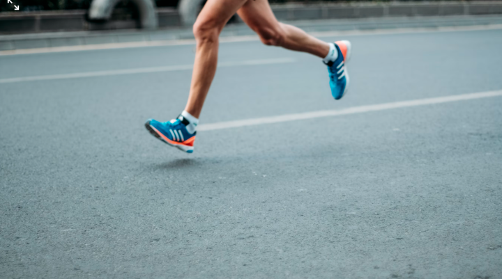 Person running on tarmac road